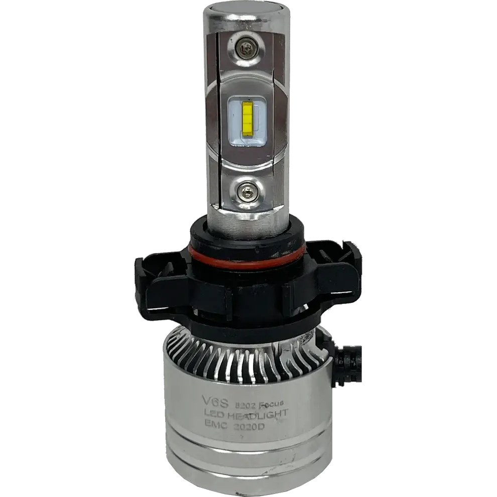 Close-up of a LUMI Stage 2 5202 LED Headlight Bulb by Lumi, featuring a silver body with cooling fins, a black plastic base, and a yellow CSP chip. The label reads V8S LED Headlight EMC 2020D. This high-performance bulb is equipped with advanced CSP chips that provide bright 6000K illumination. The background is plain white.