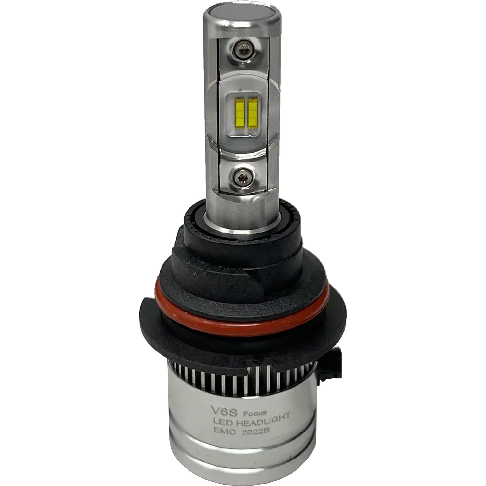 A silver LUMI Stage 2 9006 LED headlight bulb by Lumi, featuring visible yellow CSP chips, black and red rubber rings, and a cylindrical base labeled EMC 2022B, is displayed on a plain white background—ideal for those seeking modern LED headlights with a crisp 6000K output.