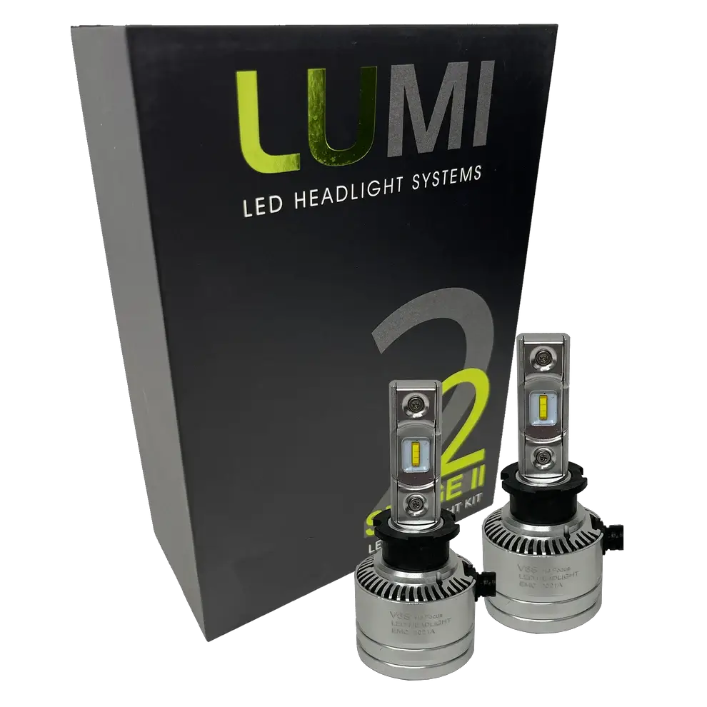 Two premium LUMI Stage 2 H3 LED Headlight Bulbs with advanced CSP chips are positioned in front of a sleek black Lumi LED Headlight Systems box labeled Stage 2, delivering brilliant 6000K color temperature illumination.