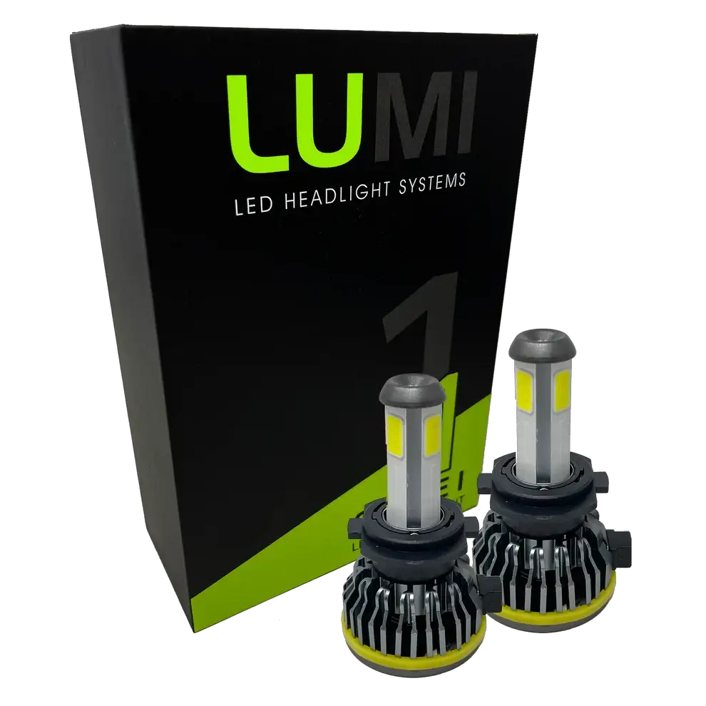 Two LUMI Stage 1 H7 LED headlight bulbs are displayed in front of a black and green Lumi box featuring bold branding. Equipped with advanced LED CANBUS technology, these 6000K, 40-watt bulbs provide bright, reliable illumination for enhanced nighttime visibility.