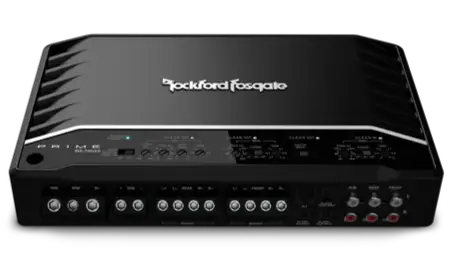 A black Rockford Fosgate car amplifier with multiple dials, ports, and indicator lights on the front panel, viewed from an angled top perspective.