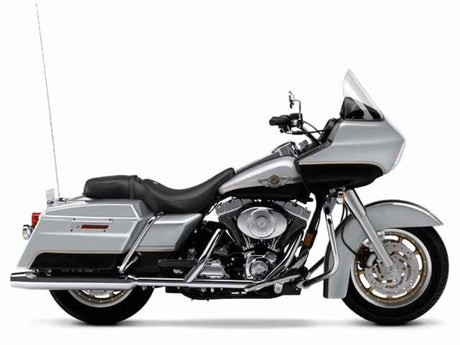 A silver touring motorcycle with a windshield, side saddlebags, and a black seat, viewed from the left side against a white background.