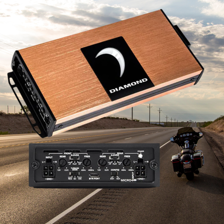 A copper-colored Diamond car amplifier is shown above a highway scene with a parked motorcycle on the roads shoulder under a partly cloudy sky.
