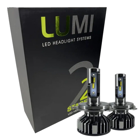 A black box labeled Lumi stands next to two LUMI Stage 2 880 LED headlight bulbs featuring metallic bases and yellow accents, all displayed against a white background.