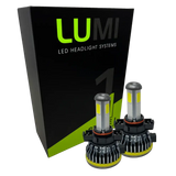 Two LUMI Stage 1 5202 LED headlight bulbs from Lumi are displayed in front of a black and green box labeled “LUMI LED Headlight Systems” on a white background, emphasizing their bright 6000K output and advanced 40-watt performance.