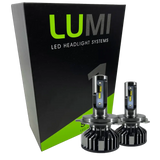 Two LUMI Stage 1 880 LED headlight bulbs from Lumi are displayed in front of a black and green box labeled “LUMI LED Headlight Systems.” With metallic bases and visible yellow LED strips, these 40 Watt, 6000K bulbs deliver brilliant illumination and are compatible with most vehicles due to their integrated LED CANBUS technology.
