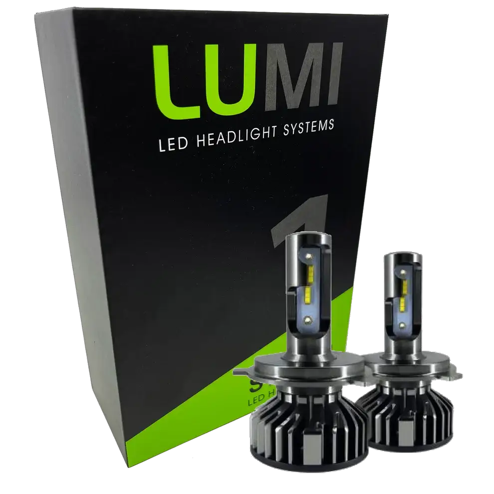 Two 40 Watt LUMI Stage 1 9007 LED Headlight Bulbs by Lumi are positioned in front of a black and green LUMI LED Headlight Systems box. The bulbs feature a metallic finish with prominent cooling fins at their bases and deliver brilliant 6000K illumination.