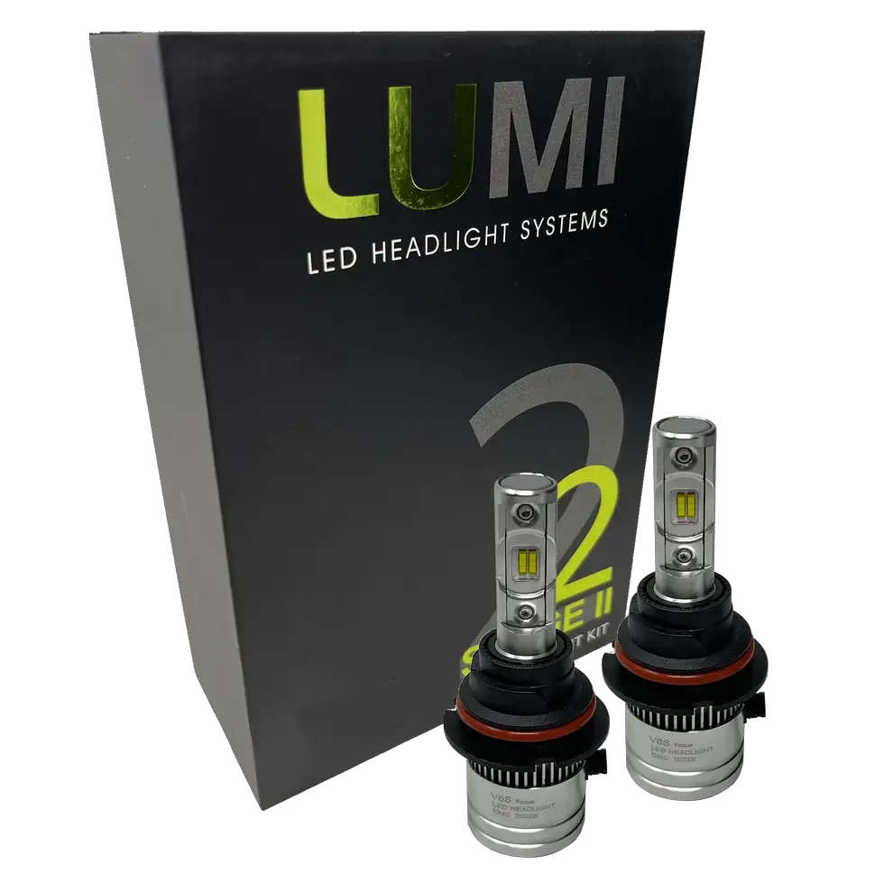 Two LUMI Stage 2 9004 LED Headlight Bulbs by Lumi are displayed in front of a black box labeled “LUMI LED Headlight Systems 2.” The bulbs have a metallic finish with prominent yellow CSP chips, delivering bright 6000K light for enhanced visibility.