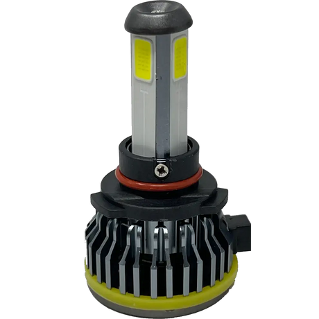 A close-up of a Lumi LUMI Stage 1 9005 LED Headlight Bulb, featuring yellow panels, black heatsink fins at the base, and a small connector on the side, isolated on a white background.