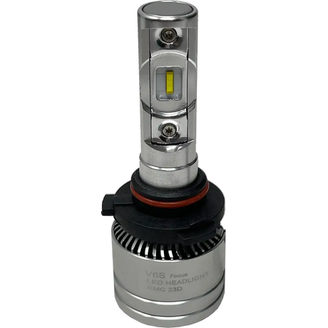 A silver LUMI Stage 2 9005 LED headlight bulb from Lumi, featuring a black and red base, finned heat sink, and a visible diode in the center marked ‘V6S Focus LED Headlight EMC 23D.’ This model utilizes high-performance CSP chips to provide a crisp 6000K color temperature for enhanced visibility.
