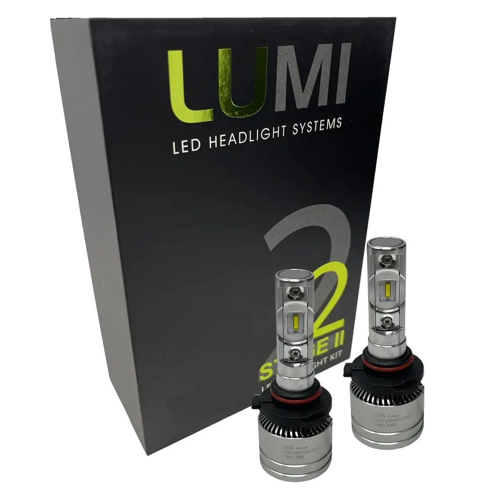 Two Lumi Stage 2 9005 LED Headlight Bulbs with advanced CSP chips are displayed in front of a black box labeled “LUMI LED Headlight Systems 2 Stage II Headlight Kit” on a plain background. Each bulb delivers an impressive 6000 lumens, ensuring bright and efficient illumination.