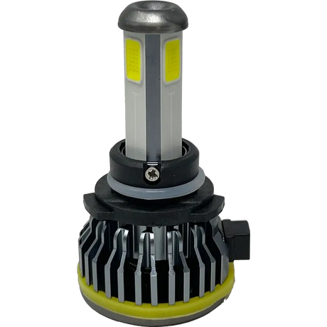 A close-up of a Lumi LUMI Stage 1 9006 LED Headlight Bulb with a silver heatsink, yellow sealing ring, and rectangular yellow LED chips engineered to deliver a crisp 6000K light output, isolated on a white background.