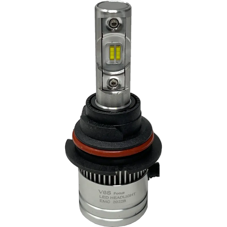 A silver LUMI Stage 2 9006 LED headlight bulb by Lumi, featuring visible yellow CSP chips, black and red rubber rings, and a cylindrical base labeled EMC 2022B, is displayed on a plain white background—ideal for those seeking modern LED headlights with a crisp 6000K output.