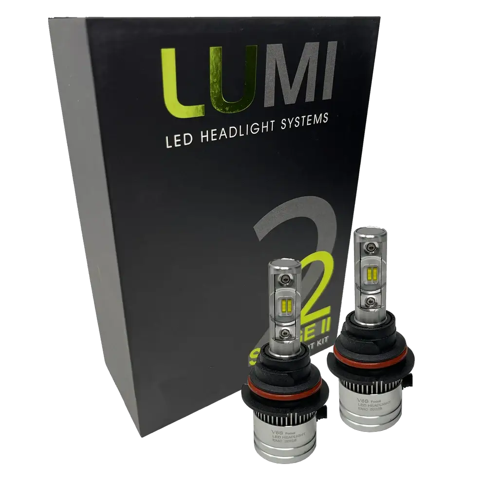 Two LUMI Stage 2 9006 LED Headlight Bulbs by Lumi, featuring advanced CSP chips and metallic bases with visible LED elements, are displayed in front of a black box labeled “LUMI LED Headlight Systems 2 Series II.” These bulbs deliver a crisp 6000K white light.