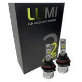 Two LUMI Stage 2 9006 LED Headlight Bulbs by Lumi, featuring advanced CSP chips and metallic bases with visible LED elements, are displayed in front of a black box labeled “LUMI LED Headlight Systems 2 Series II.” These bulbs deliver a crisp 6000K white light.