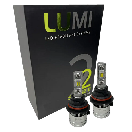 Two LUMI Stage 2 9006 LED Headlight Bulbs by Lumi, featuring advanced CSP chips and metallic bases with visible LED elements, are displayed in front of a black box labeled “LUMI LED Headlight Systems 2 Series II.” These bulbs deliver a crisp 6000K white light.