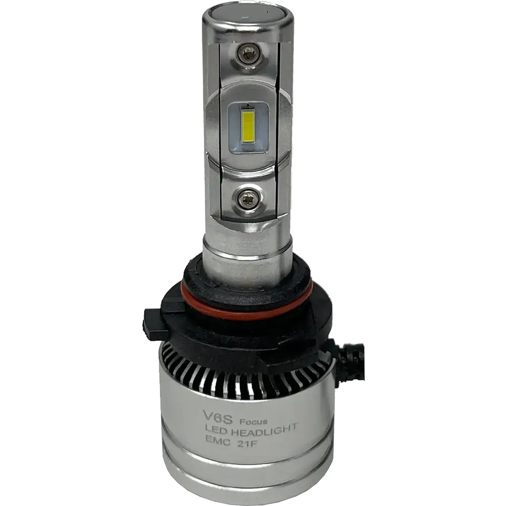 Introducing the LUMI Stage 2 9007 LED Headlight Bulbs by Lumi: Featuring a silver design with integrated cooling fins, a black and red gasket at the base, and visible CSP chips on the front for improved brightness. The bulbs include a black connector attached at the bottom, and “V6S Focus LED HEADLIGHT EMC 21F” printed on the base. These Lumi headlights emit a crisp 6000K white light, delivering superior visibility for nighttime driving.