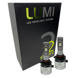 Two LUMI Stage 2 H10 LED Headlight Bulbs from Lumi, each delivering a bright 6000LM output with high-quality CSP chips, are displayed in front of a black Lumi LED Headlight Systems Stage 2 box against a white background.
