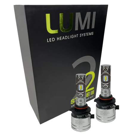 Two LUMI Stage 2 H10 LED Headlight Bulbs from Lumi, each delivering a bright 6000LM output with high-quality CSP chips, are displayed in front of a black Lumi LED Headlight Systems Stage 2 box against a white background.