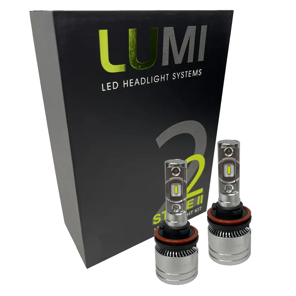 Two metallic Lumi Stage 2 H11 LED Headlight Bulbs, equipped with advanced CSP chips and delivering a crisp 6000K color temperature, are displayed in front of a black Lumi LED Headlight Systems box featuring “Stage II” and “2” branding.