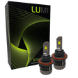 Two LUMI Stage 3 H4 LED Headlight Bulbs by Lumi, featuring metallic bases with cooling fins and visible yellow CSP chips on their flat tops, are positioned in front of a black Lumi box adorned with green and yellow geometric lines.