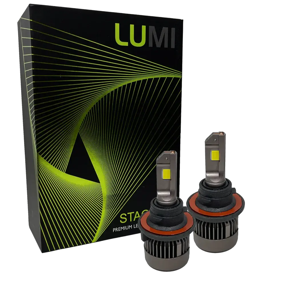 Two LUMI Stage 3 H4 LED Headlight Bulbs by Lumi, featuring metallic bases with cooling fins and visible yellow CSP chips on their flat tops, are positioned in front of a black Lumi box adorned with green and yellow geometric lines.