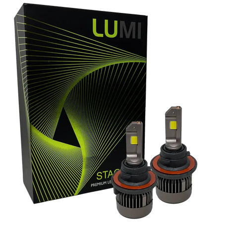 Two LUMI Stage 3 H13 LED headlight bulbs featuring advanced CSP chips are displayed in front of a black Lumi-branded box with green lines and patterns. The bulbs have metallic bases and visible yellow LED chips, delivering brilliant 6000K illumination for superior visibility.