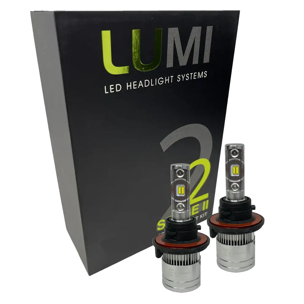 Two LUMI Stage 2 H13 LED Headlight Bulbs by Lumi, featuring advanced CSP chips, are displayed in front of a black box labeled “LUMI LED Headlight Systems 2 Stage II Series Kit.”.