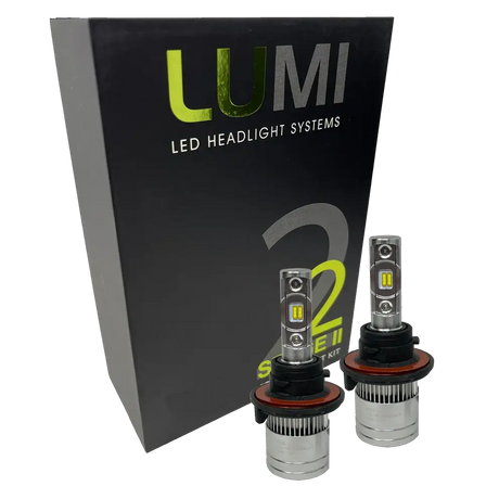 Two LUMI Stage 2 H13 LED Headlight Bulbs by Lumi, featuring advanced CSP chips, are displayed in front of a black box labeled “LUMI LED Headlight Systems 2 Stage II Series Kit.”.