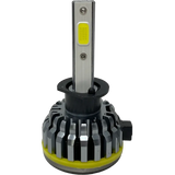 A close-up of a single Lumi LUMI Stage 1 H1 LED headlight bulb featuring a silver heat sink and a yellow LED chip on a metallic stem, set against a plain white background.