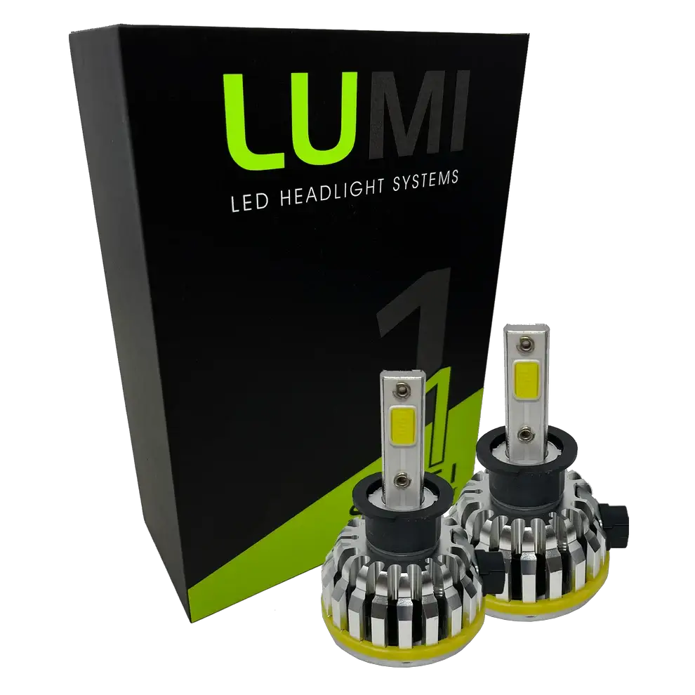 Two LUMI Stage 1 H3 LED headlight bulbs with metallic heatsinks are positioned in front of a black and green Lumi LED Headlight Systems box on a white background, showcasing advanced LED CANBUS compatibility and an impressive 40-watt power output.