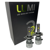 Two LUMI Stage 2 H4 LED Headlight Bulbs with advanced CSP chips are displayed in front of a black Lumi LED Headlight Systems box featuring green and white text, highlighting their brilliant 6000K illumination.