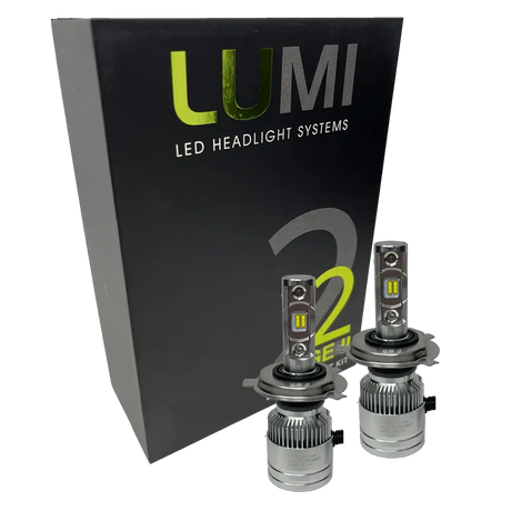 Two LUMI Stage 2 H4 LED Headlight Bulbs with advanced CSP chips are displayed in front of a black Lumi LED Headlight Systems box featuring green and white text, highlighting their brilliant 6000K illumination.