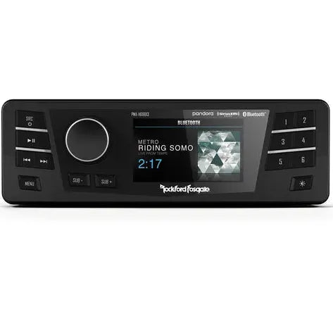The Rockford Fosgate Digital Media Receiver for Select 1998-2013 Harley-Davidson Models (PMX-HD9813) is shown in black, featuring a digital display with “Metro Riding Somo 2:17” on the screen, control buttons, a large knob, and visible Bluetooth, Pandora, and SiriusXM logos—ensuring easy plug-and-play installation for your Harley-Davidson motorcycle.